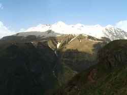 WS T/L Shot of Caucasus mountains valley and snowy peaks / Stepantsminda, Kazbegi, Georgia   Stock Footage