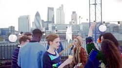 Musicians performing for dancing friends at urban rooftop party Stock Footage