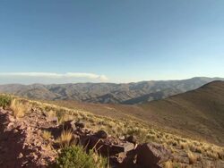 Mountain range with blue sky from outside small rural town, Potolo, Bolivia Stock Footage
