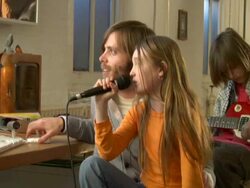 MS,  PAN,  Father with two children  (8-9, 10-11)  playing and singing at home Stock Footage