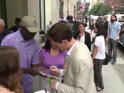 Neil Patrick Harris (Hedwig & the Angry Inch) wearing red nail polish exits The Huffington Post & signs for fans & poses for photographers before leaving Stock Footage