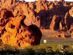 ZO open convertible car driving through red rock formations in Valley of Fire State Park / Overton, Nevada, USA Stock Footage