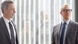 MS Smiling businessman discussing project with colleagues during informal meeting in office Stock Footage