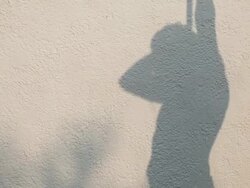 Silhouette of man taking a shower form water tube Stock Footage