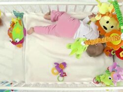 HD CRANE: Baby Rolling In Crib Stock Footage