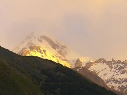 WS T/L Shot of Kazbegi mountain and snowy peaks of caucasus at sunrise / Stepantsminda, Kazbegi, Georgia Stock Footage