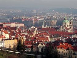 Vltava River, Bridges, Red Roofs & St. Nicholas Church Stock Footage