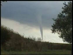 MS zooming out to WA, gyrating column of water, waterspout rising upwards, over countryside, UK (caused by whirlwind) Stock Footage