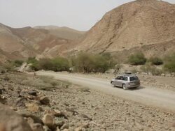 Two cars riding through mountain landscape Stock Footage