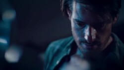 Man in motorcycle workshop looking at his bike Stock Footage