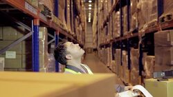 Man with clipboard taking inventory in distribution warehouse Stock Footage