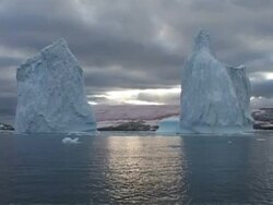 MS pink snow algae, zoom out between two large icebergs, Antarctica Stock Footage