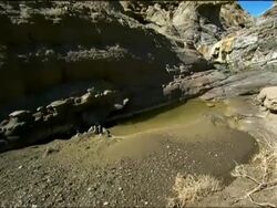 Pan up from rocky pool to sky, Tabernas Desert, Andalucia, Spain Stock Footage