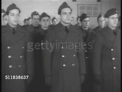 1941: US ARMED SERVICES: US Army recruits in coats standing at attention. CU Young adult male in uniform. MS Recruits at attention in uniform. WS Car approaching guarded security gate at Brooklyn Navy Yard, handing guard identification. Instructional Video