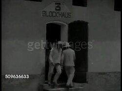 1940: FRENCH GUIANA (Iles du Salut): GRAPHIC: Prisoner trustee adjusting leg irons on Asian male sitting in solitary bunk, crying. BLOCKHAUS 3: VS Prisoners walking out door. Prisoners, exiles walking in circle in prison yard, daily exercise. Instructional Video