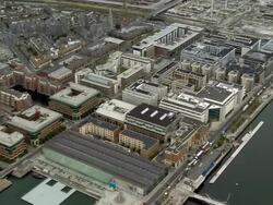 Aerial wide shot pan buildings in docks district/ Dublin, Ireland Stock Footage