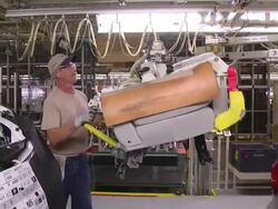 MS PAN Worker using lift arm to installing rear seat in minivan / Princeton, Indiana, United States Stock Footage