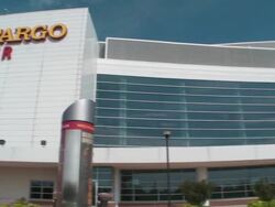 Shot of the exterior of the Wells Fargo Center in Philadelphia, Pennsylvania. Shot starts on far end of building and pans to reveal the front of the building Stock Footage