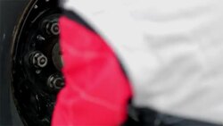 A pit crewman tightens the lug nuts on a stock car. Stock Footage