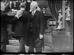 B/W 1900s Buffalo Bill Cody in suit doing secret handshake with line of men / newsreel Stock Footage