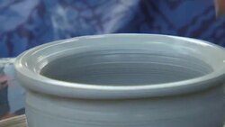 man creates pottery on a potter's wheel Stock Footage