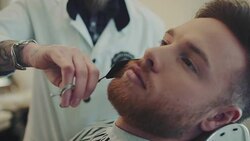 Barber cutting beard Stock Footage