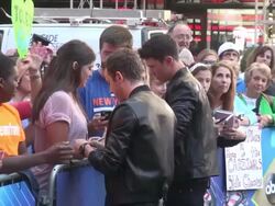 Cal Shapiro & producer Rob Resnick (Timeflies ) greet, sign for & pose with fans on the outside set of the Good Morning America show in Times Square Stock Footage
