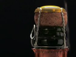 MS Hand removing copper colored foil from champagne bottle top and twists opening metal wire / Los Angeles, California, United States Stock Footage