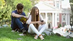 Man with book and girl with smartphone. Stock Footage