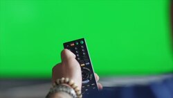 Guys sitting on couch watching tv and switching Stock Footage