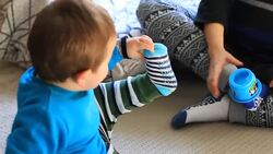Toddler Playing with Foot Stock Footage