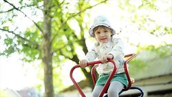 Girl playing on seesaw. Slow motion Stock Footage