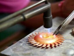 Goldsmith Jeweler use gasoline burner melting and decorating gold Stock Footage