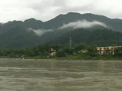 Pan right flowing ganges river haridwar uttarakhand Stock Footage