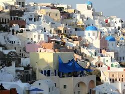 The beautiful town of Oia with people enjoying a drink at the local Cafe, bar overlooking the sea, Oia, Island of Santorini, Aegean Sea, Greece, Europe Stock Footage