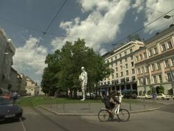 Bayerischer Hof, Hotel, sculpture of Graf von Montgelas, trees, street, cars, people, Stock Footage