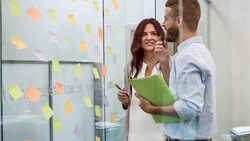 Business people looking at adhesive notes in conference room Stock Footage