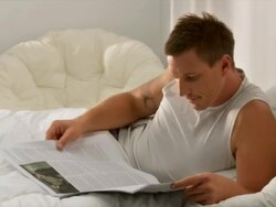 HD DOLLY: Young Man Reading In Bed Stock Footage