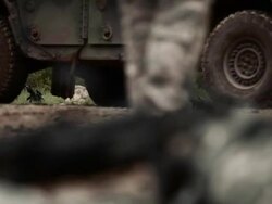 Ground level shot of a machine gun, near a military jeep. Stock Footage