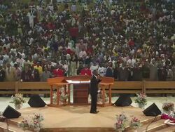 MS View of Large church interior filling up with people praying, singing and dancing / Lagos, Nigeria Stock Footage