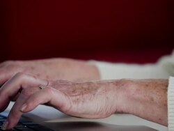CU tilt up senior woman using laptop Stock Footage