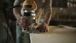 White Male Carpenter in his Forties Routers a Piece of Wood Stock Footage