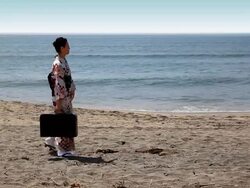 Japanese woman traveling by the shore Stock Footage