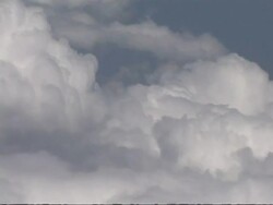 Cotton wool clouds against blue sky from aircraft window, CU, Europe Stock Footage