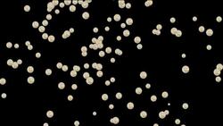 An image of silver coins floating downward against a black background transforms into a silhouette of the image. Stock Footage