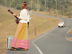 Hippie woman playing music and dancing Stock Footage