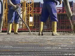 MS Workers Directing Concrete Onto The Construction Site Stock Footage