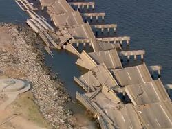 Aerial over parts of I-90 fallen into Bay of Biloxi from Biloxi-Ocean Springs Bridge / Mississippi Stock Footage
