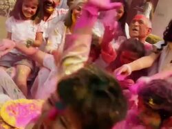 Family celebrating holi festival in the lawn  Stock Footage
