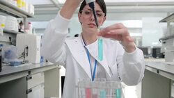 Scientist pouring liquid into test tube in laboratory Stock Footage